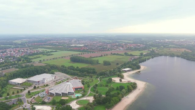 Wolfsburg, Germany: Aerial view of city in Lower Saxony, lake Allersee in morning - landscape panorama of Europe from above