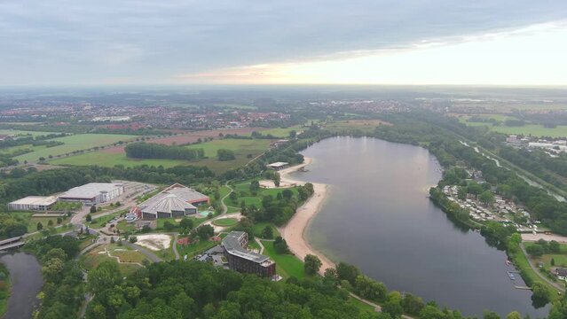 Wolfsburg, Germany: Aerial view of city in Lower Saxony, lake Allersee in morning - landscape panorama of Europe from above