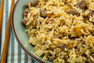 close up of a beef fried rice in a plate on a table
