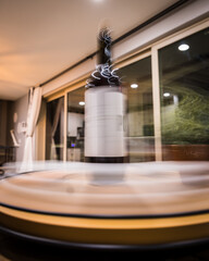 Wine bottle sits on a spinning mount in motion