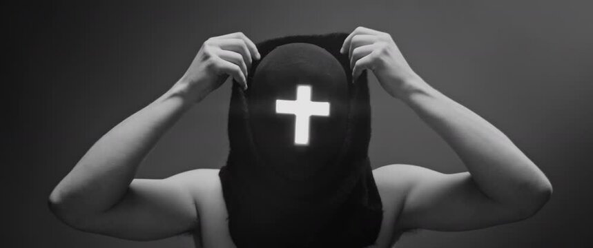Man wearing a cross and black robes - Black and White