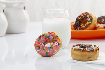 Closeup of donuts near a cup of milk - Powered by Adobe
