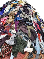 large pile stack of textile fabric clothes and shoes. concept of recycling, up cycling, awareness to global climate change, fashion industry pollution, sustainability, reuse of garment - obrazy, fototapety, plakaty
