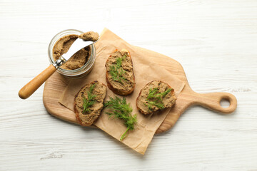Slices of bread with delicious pate and dill on white wooden table, top view - obrazy, fototapety, plakaty