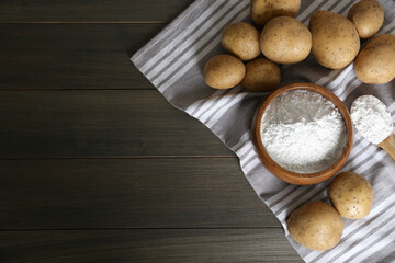 Starch and fresh raw potatoes on wooden table, flat lay. Space for text