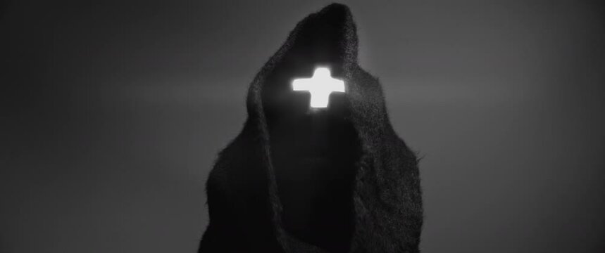 Man wearing a cross and black robes - Black and White
