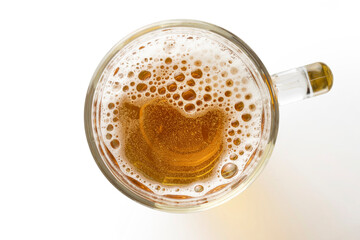 Light beer with foam in a mug, isolated on white, top view