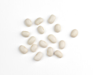 heap of white beans on white background, top view