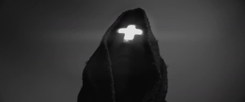 Man wearing a cross and black robes - Black and White