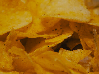 Spiced potato chips, a close-up shot. Fried potatoes.