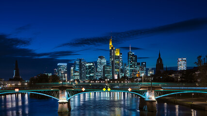Illuminated Frankfurt am Main skyline against a blue night sky © Andy-27/Wirestock Creators