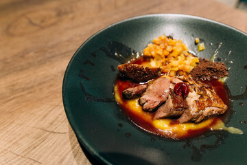fried meat beef red sauce black plate