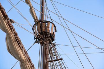 Old wooden sailing ship mast and sails, caravel, pirate ship