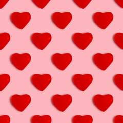 Seamless pattern with jelly candy in the form of heart on pink background.