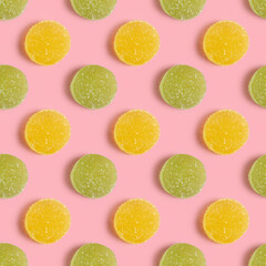 Seamless pattern with marmalade candies on pink background.