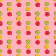 Seamless pattern with marmalade candies on pink background.