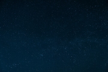 Beautiful night landscape. Stars in a clear sky without moon and clouds. Night scene over the roof of the house