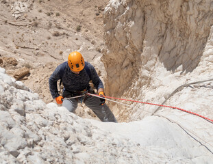 An experienced athlete starts the descent with the equipment for snapping in the mountains of the...