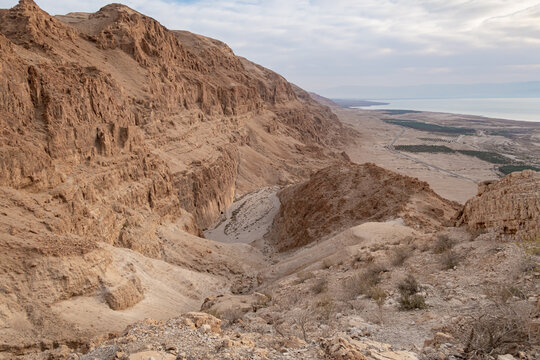 View  from a mountain near the Tamarim stream on the Israeli side of the Dead Sea at sunrise over the Dead Sea and over the mountains on the Jordan side near Jerusalem in Israel