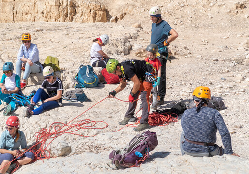Experienced athletes check their snapping equipment before going down the mountain in the mountains of the Judean Desert near the Tamarim stream near Jerusalem in Israel