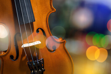 Musical instrument, violin on a colorful bokeh background.