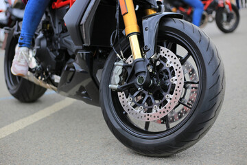 Fototapeta na wymiar Motorcycle front wheel on the street