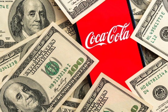 Coca-cola stock market price. Logo close-up view and dollar money background. Business and finance concept photo