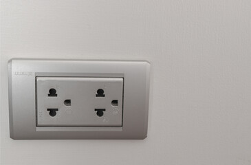 Electrical switch and plug on wall white
