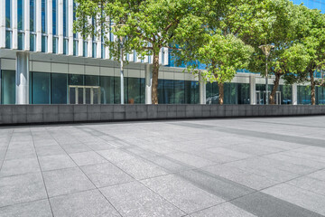 empty brick floor front of modern buildings.