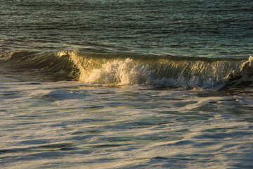 sunlight reflected in the waves of the surf in the Northsea coast of Goeree Overflakkee