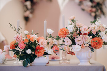elegant flower arrangements on the reception desk of the wedding table