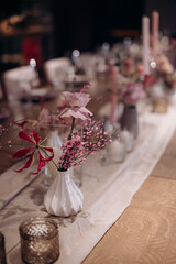 rustic flower arrangement in the decor of a wedding banquet table
