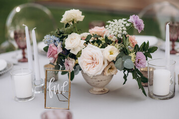 elegant flower arrangements on the reception desk of the wedding table