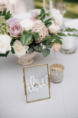 elegant flower arrangements on the reception desk of the wedding table