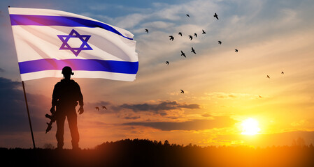 Silhouettes of soldiers with Israel flag and flying birds against the sunrise in the desert....