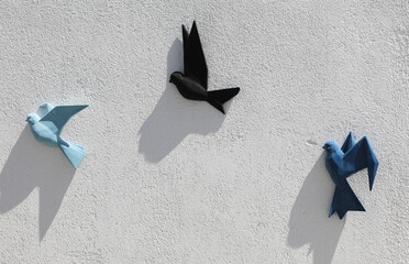 decorative flock of birds on white wall