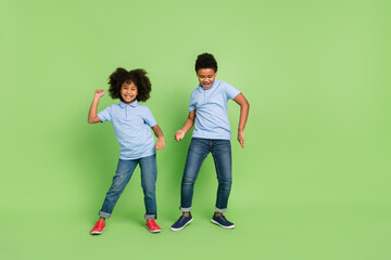 Full length body size view of attractive cheerful pre-teen people dancing having fun isolated over green color background