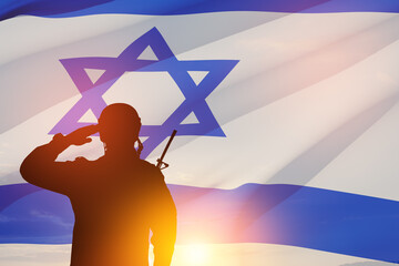 Silhouette of soldiers saluting against the sunrise in the desert and Israel flag. Concept - armed...