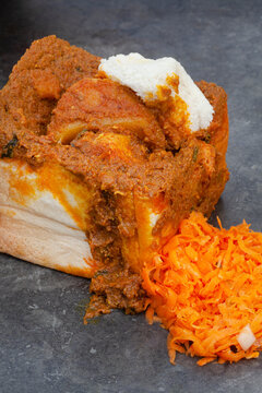 
Traditional South African Bunny Chow, Hollowed Out White Bread Loaf Filled With Curry
