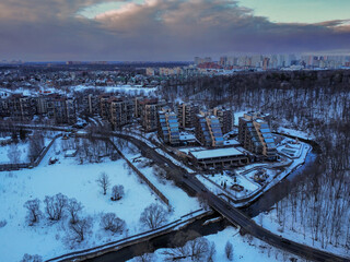 Aerial view of residental complex Novogorsk Olympic village in the evening at sunset. River like a...