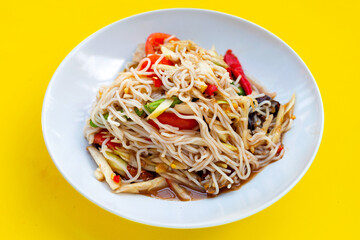 Spicy green papaya salad with vermicelli on white