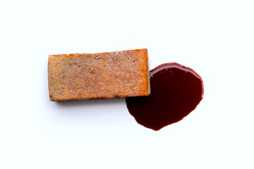 Brick with blood on white background.