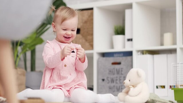 eco wood toy baby game, Little clever caucasian child playing natural toys on floor at home, Educational games for early development