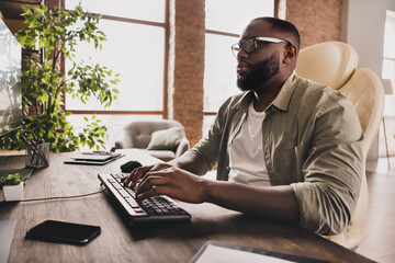 Profile side view portrait of attractive focused guy expert typing remote technical support at...