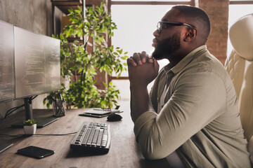 Profile side view portrait of attractive focused guy tech leader analyzing html css at workplace workstation indoors