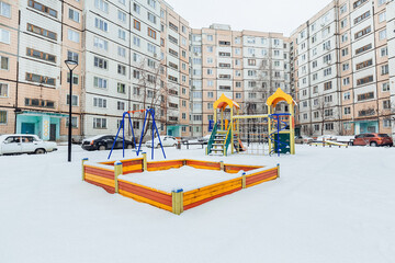 Fototapeta na wymiar playground with slides in the yard in winter