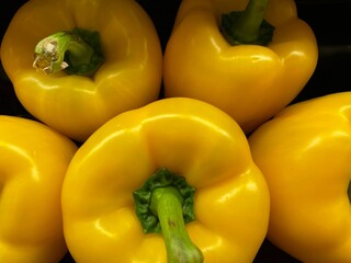 Yellow peppers in a retail store produce department