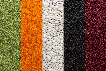 Different types of legumes, lentils and green peas, red, white and black beans, top view