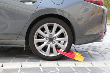 the wheel of the car is blocked for violating the rules. punishment. police. fine. is isolated on a white background.