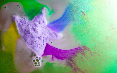 The star-shaped bath bomb dissolves with multicolored paints in water